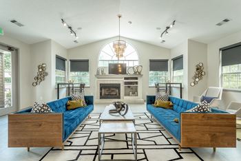 a living room with blue couches and a fireplace